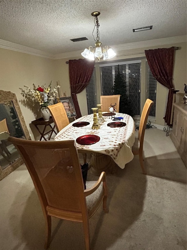 carpeted dining area featuring a notable chandelier, ornamental molding, and a textured ceiling