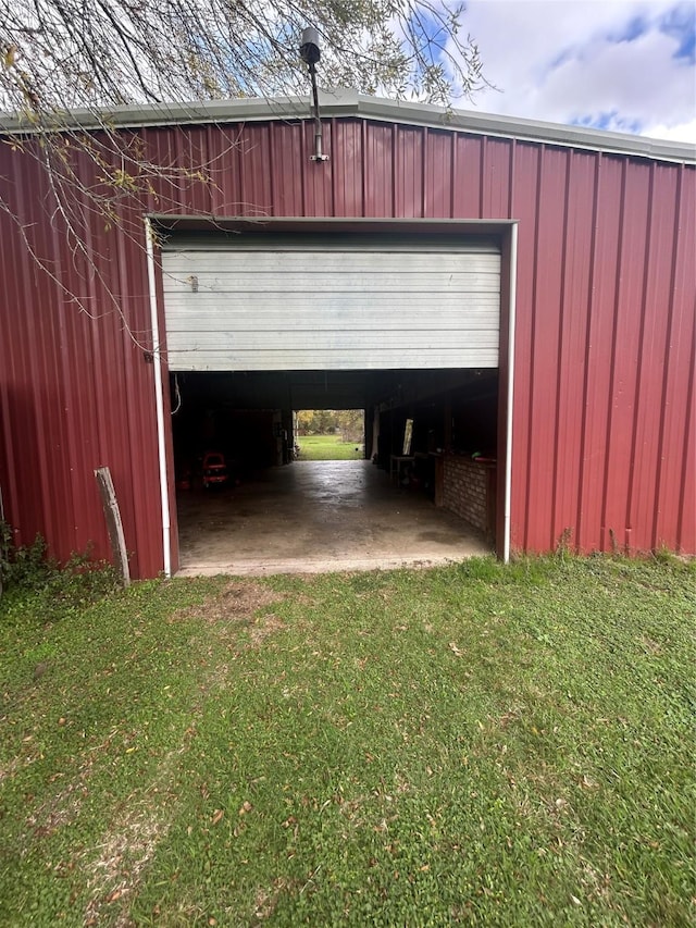 garage featuring a lawn