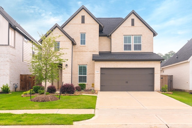 view of front of house with a front lawn and a garage