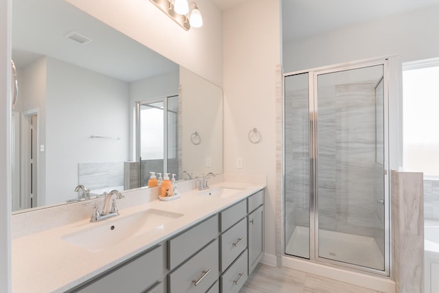 bathroom with vanity and independent shower and bath