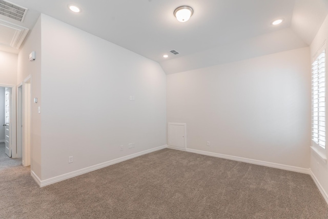 unfurnished room with carpet and vaulted ceiling