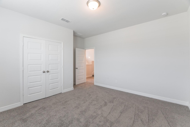 unfurnished bedroom featuring carpet and a closet