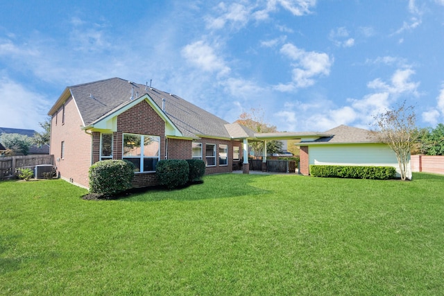 view of front facade with a front yard and central AC