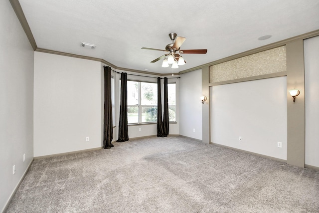 carpeted spare room featuring a textured ceiling, ceiling fan, and crown molding