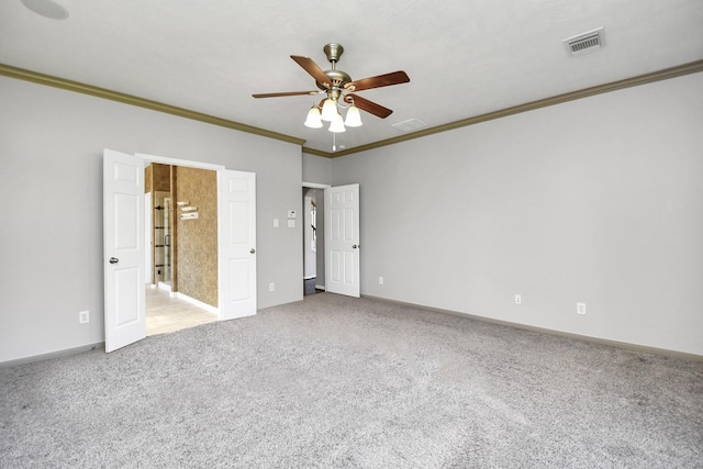 unfurnished bedroom with carpet flooring, ceiling fan, ensuite bathroom, and crown molding