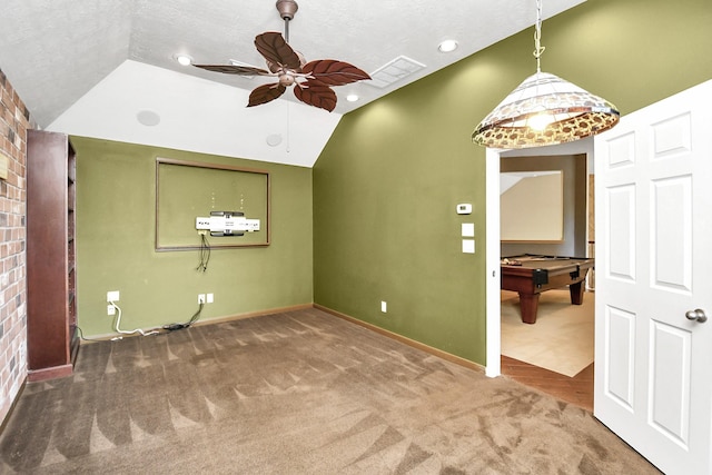 interior space with lofted ceiling, carpet flooring, ceiling fan, a textured ceiling, and pool table