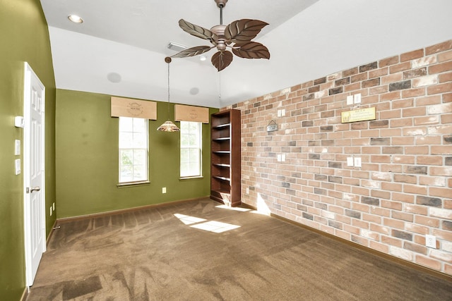 unfurnished room with ceiling fan and carpet