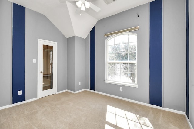 spare room featuring carpet, ceiling fan, and lofted ceiling