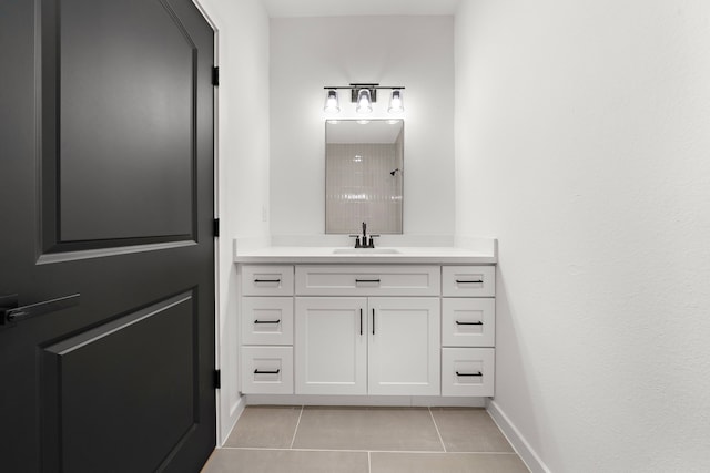 bathroom featuring tile patterned flooring, a shower, and vanity