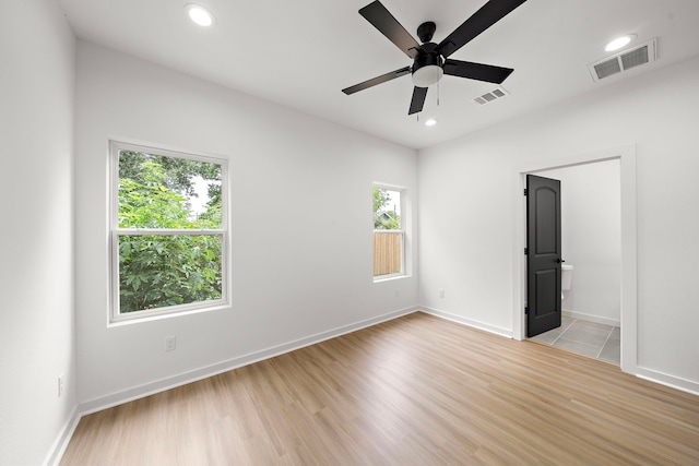 unfurnished room featuring ceiling fan, a healthy amount of sunlight, and light wood-type flooring