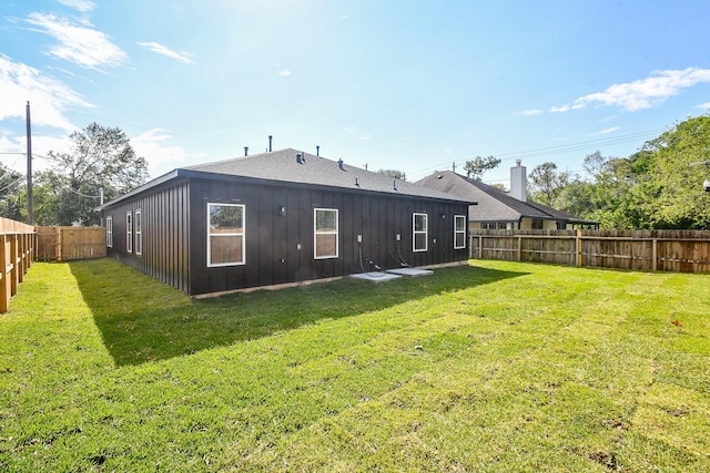 rear view of house featuring a lawn