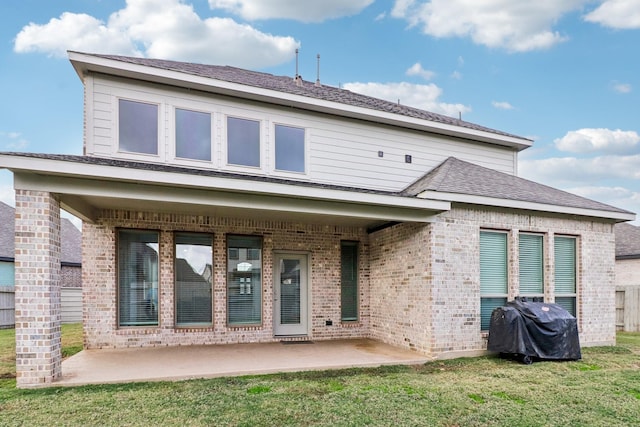 rear view of house with a yard and a patio