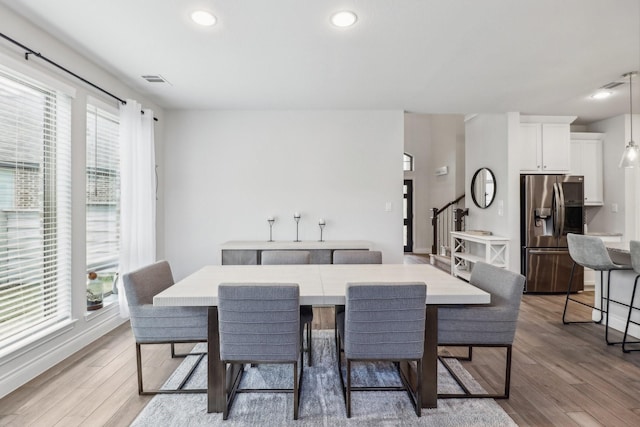 dining room with plenty of natural light and light wood-type flooring