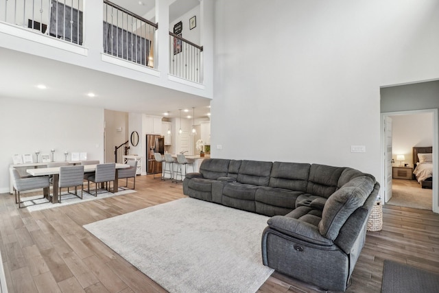 living room featuring a high ceiling and hardwood / wood-style floors