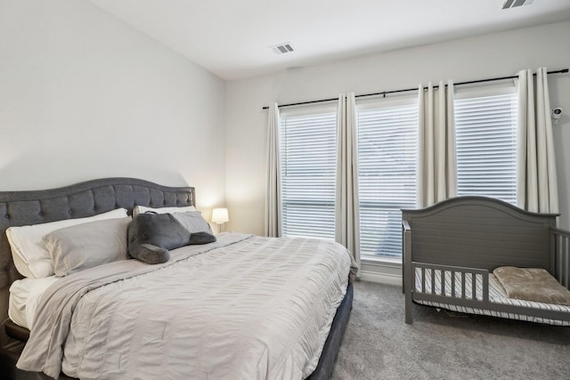 bedroom featuring carpet and multiple windows