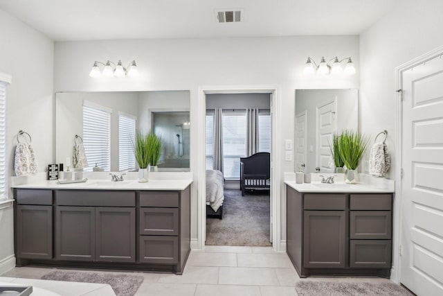 bathroom featuring tile patterned flooring, vanity, and a healthy amount of sunlight