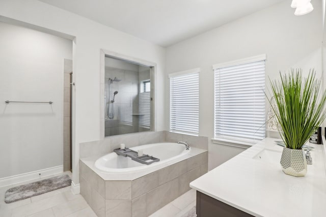 bathroom featuring tile patterned floors, vanity, and shower with separate bathtub