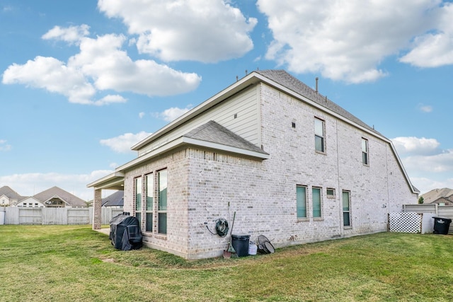 rear view of house featuring a lawn