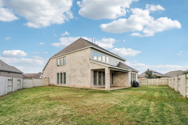 back of property featuring a patio area and a yard