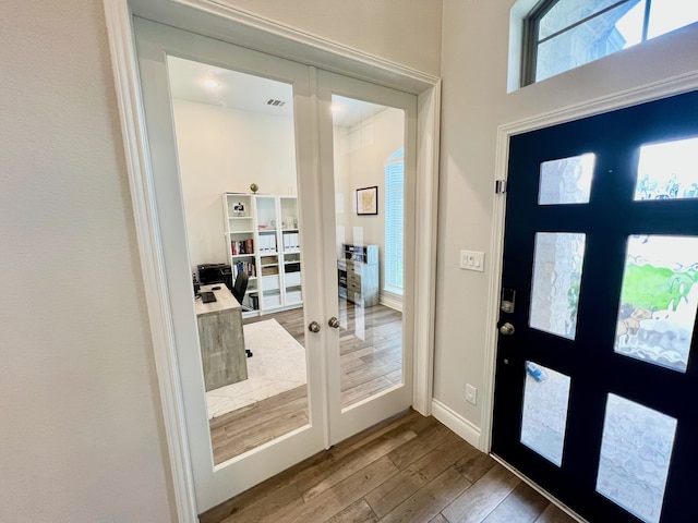 entrance foyer with french doors and hardwood / wood-style floors