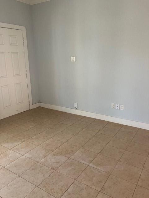 unfurnished room with light tile patterned floors