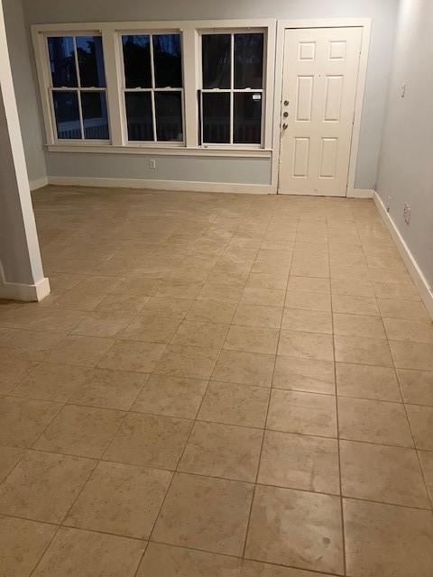 empty room with light tile patterned floors