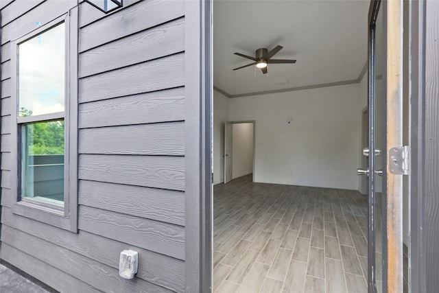 interior space featuring light wood-type flooring and crown molding