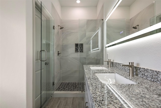 bathroom featuring vanity and a shower with shower door