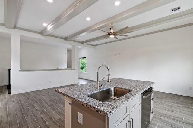 kitchen with white cabinets, sink, stainless steel dishwasher, light wood-type flooring, and light stone counters