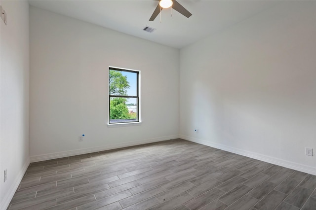 spare room featuring ceiling fan and light hardwood / wood-style flooring