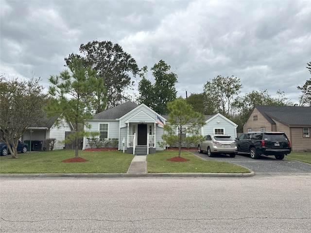 bungalow-style house with a front lawn