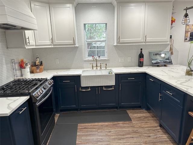 kitchen with white cabinetry, sink, stainless steel range with gas cooktop, blue cabinets, and custom exhaust hood