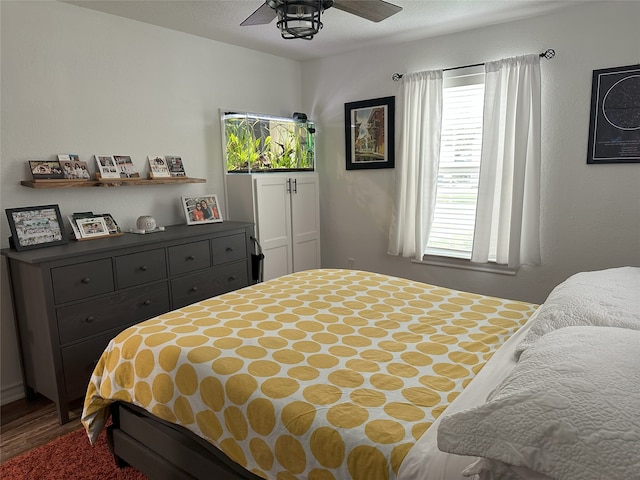 bedroom with hardwood / wood-style floors and ceiling fan