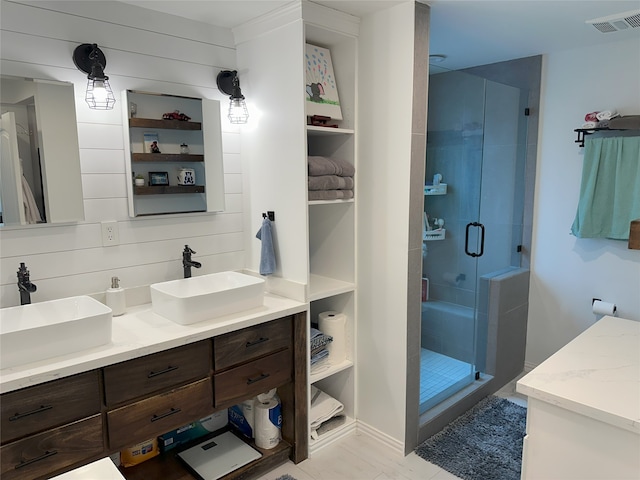 bathroom featuring vanity and an enclosed shower