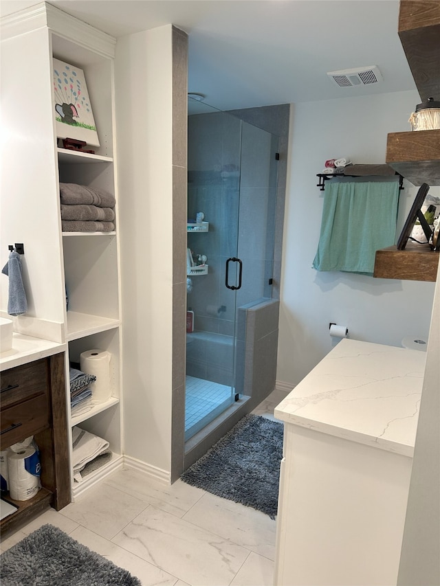 bathroom featuring vanity and an enclosed shower