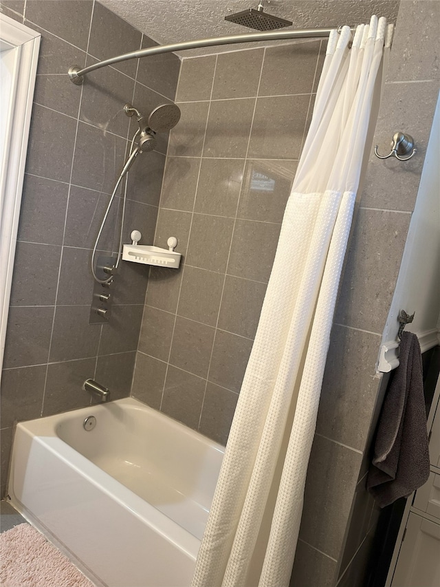 bathroom featuring a textured ceiling and shower / tub combo