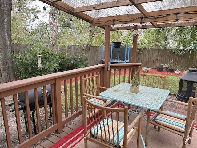 wooden deck featuring a trampoline