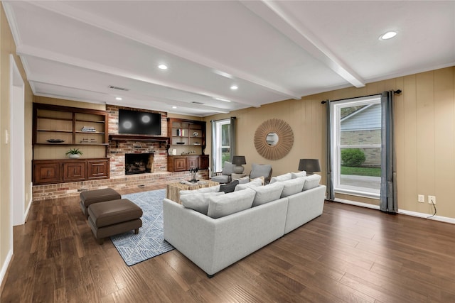 living room featuring a fireplace, beam ceiling, dark hardwood / wood-style floors, and wooden walls