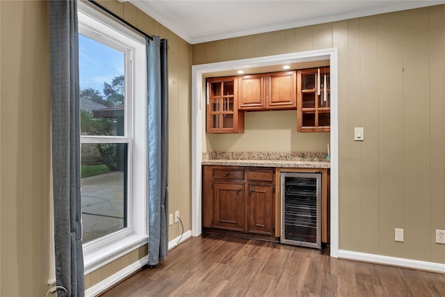 bar featuring dark hardwood / wood-style flooring, wine cooler, and ornamental molding