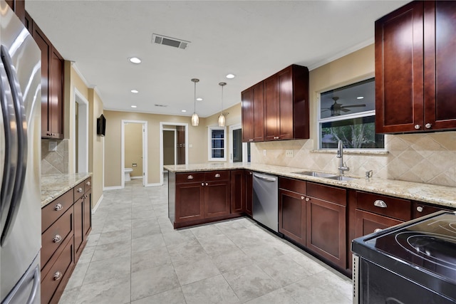 kitchen featuring sink, stainless steel appliances, light stone counters, kitchen peninsula, and pendant lighting