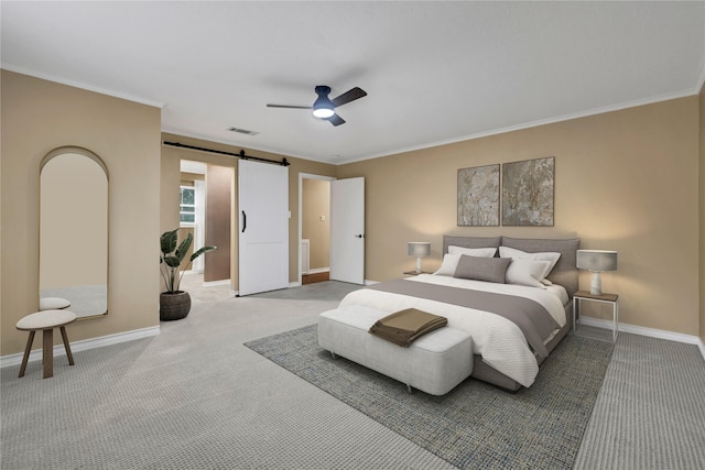 bedroom with a barn door, ceiling fan, carpet floors, and ornamental molding