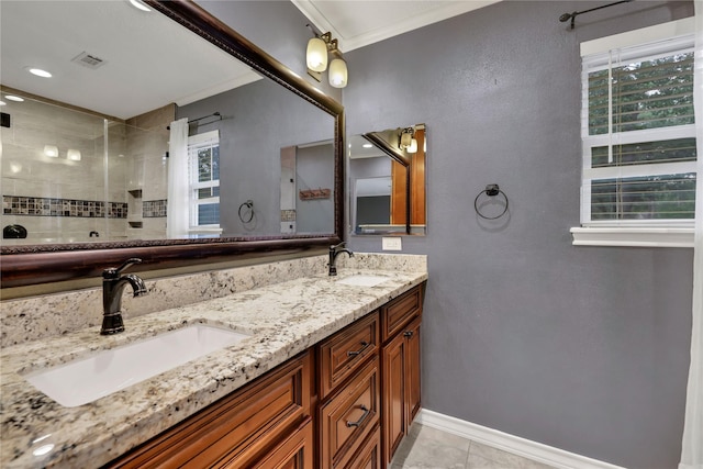 bathroom featuring a tile shower, crown molding, tile patterned floors, and vanity