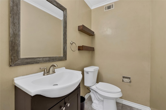 bathroom with tile patterned flooring, vanity, toilet, and ornamental molding