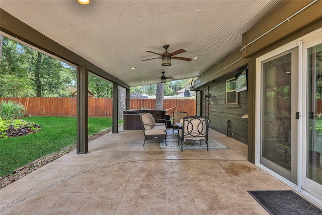 view of patio / terrace featuring outdoor lounge area, ceiling fan, and a hot tub