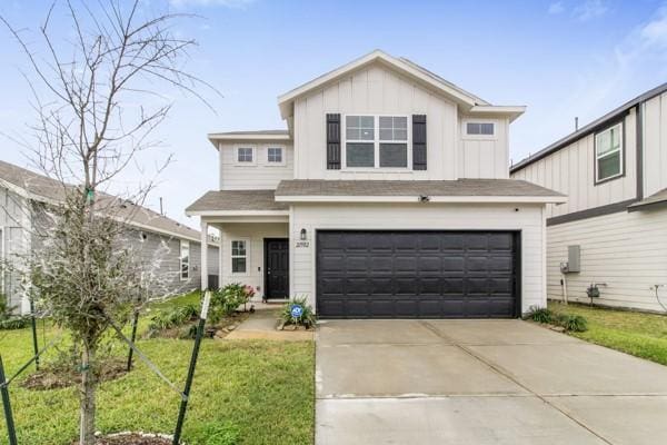 view of front facade featuring a garage and a front lawn