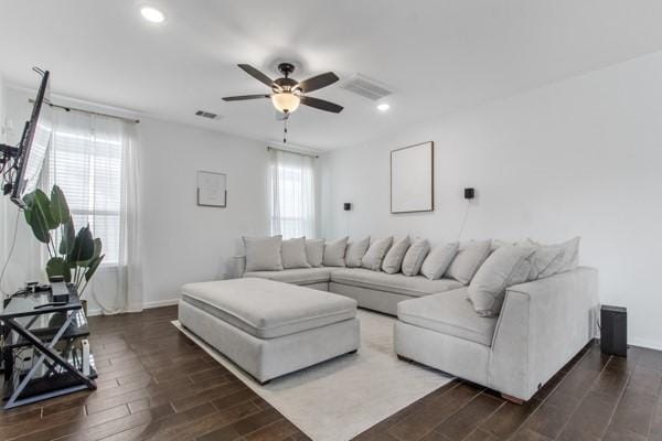 living room with plenty of natural light, dark hardwood / wood-style floors, and ceiling fan