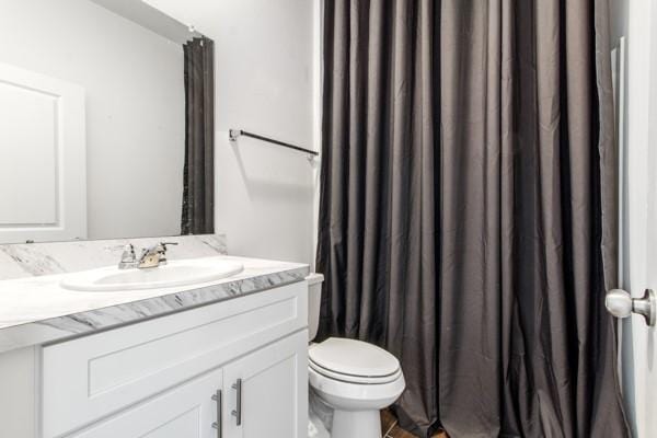 bathroom featuring vanity and toilet