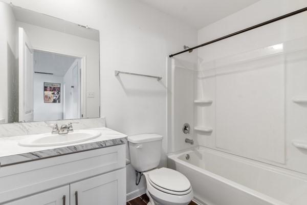 full bathroom featuring vanity, toilet, and shower / tub combination