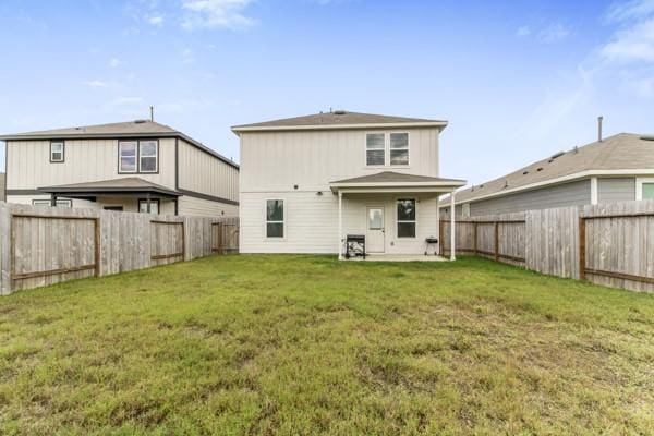 rear view of property with a lawn