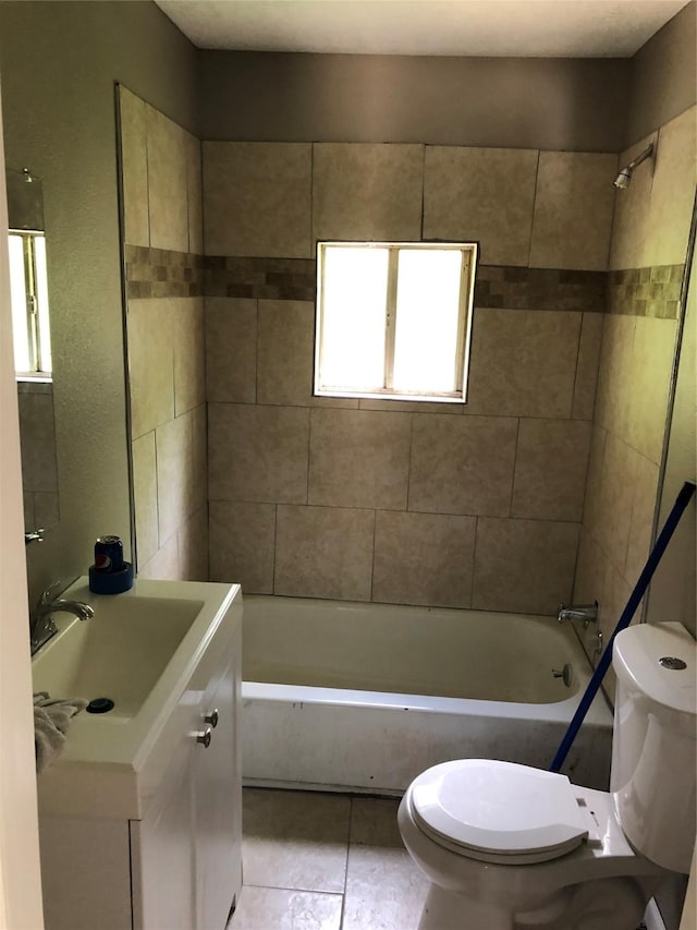 full bathroom with tile patterned flooring, vanity, toilet, and tiled shower / bath